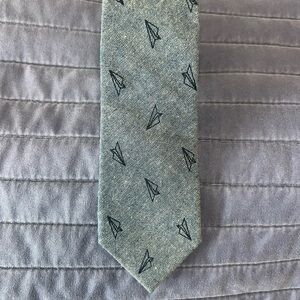 Children’s tie, blue with dark blue paper planes.